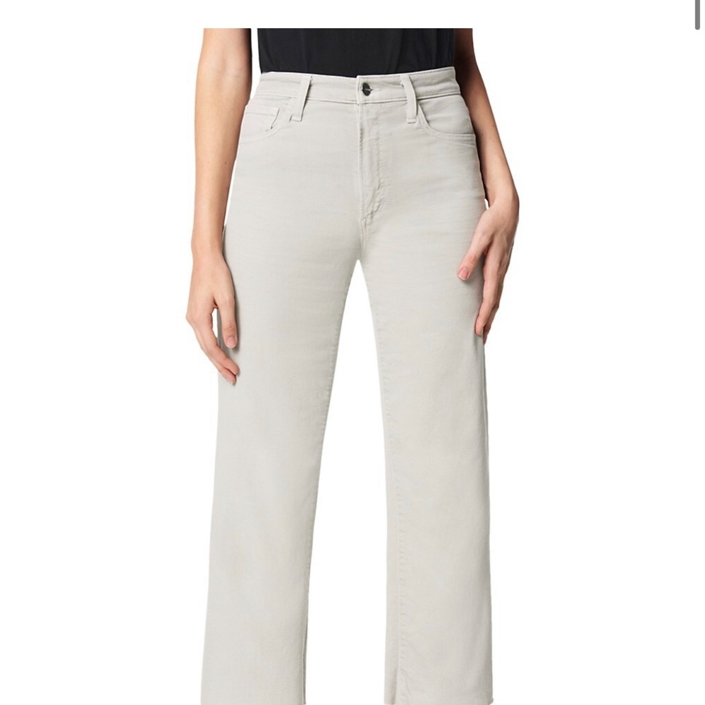 The Blake in Beach Sand is a high-rise white jean with wide legs and cut hems